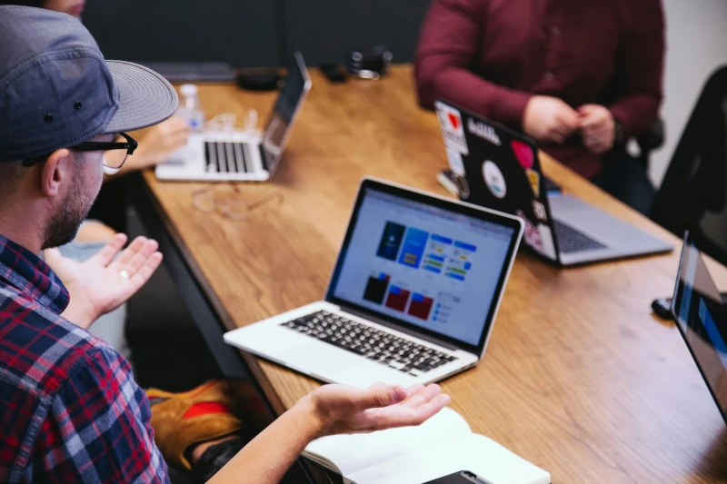 people around a table discussing business or tech